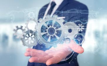 Business man holding up wheel cog imagery